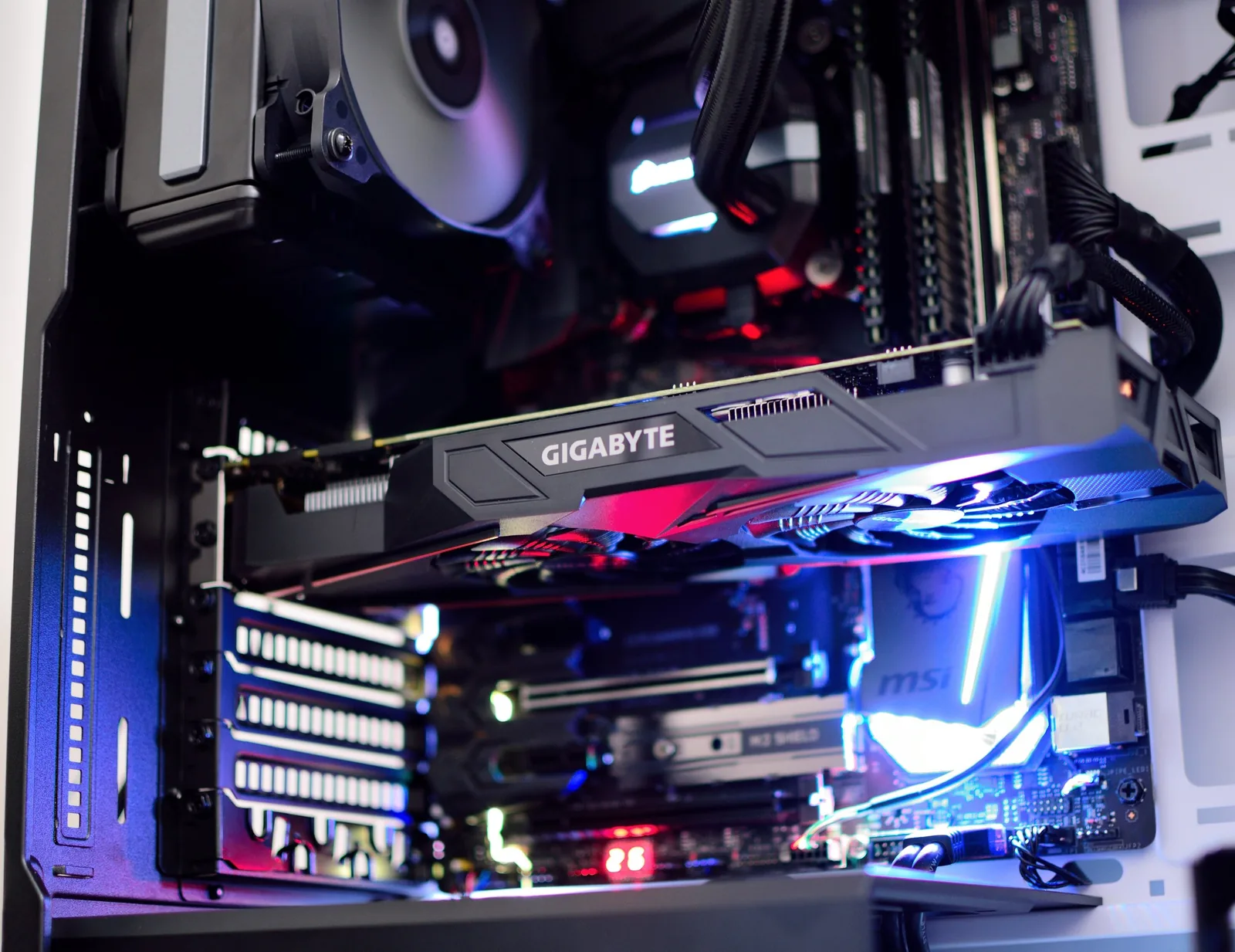 Inside a desktop PC, a graphics card lit in blue and red