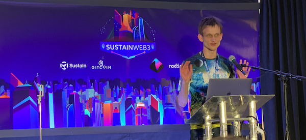 Vitalik Buterin speaking at a lectern at Sustain Web3